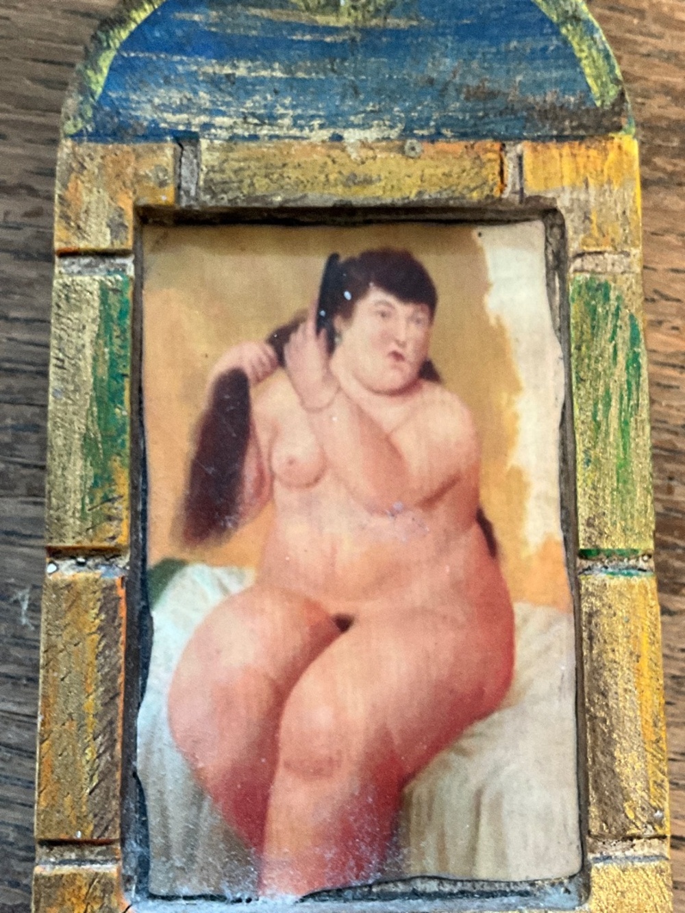 Framed picture of lady combing hair, Botero style